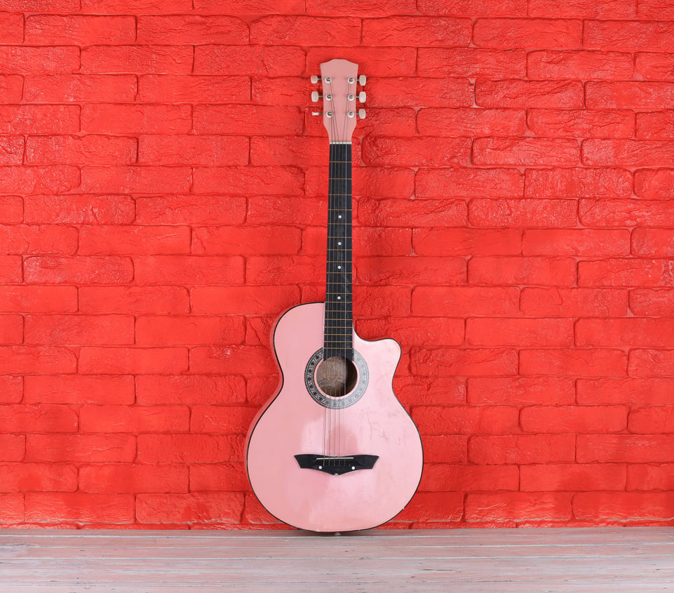 pink guitar and vintage pink travel suitcase